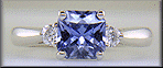 Radiant-cut sapphire set with two round diamonds in a hand-crafted platinum ring. (J8522)