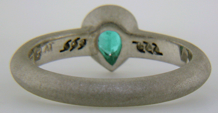 Inside view of Paraiba tourmaline accented with diamonds in a custom platinum ring.