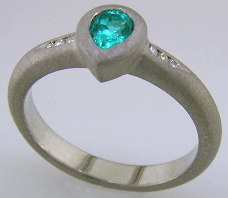 Pear-shape Paraiba tourmaline accented with diamonds in a custom platinum ring.