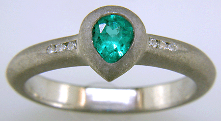 Pear-shape Paraiba tourmaline accented with diamonds in a custom platinum ring.