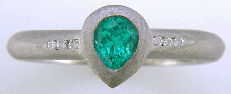 Pear-shape Paraiba tourmaline accented with diamonds in a custom platinum ring.
