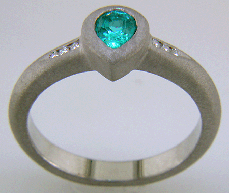 Pear-shape Paraiba tourmaline accented with diamonds in a custom platinum ring.