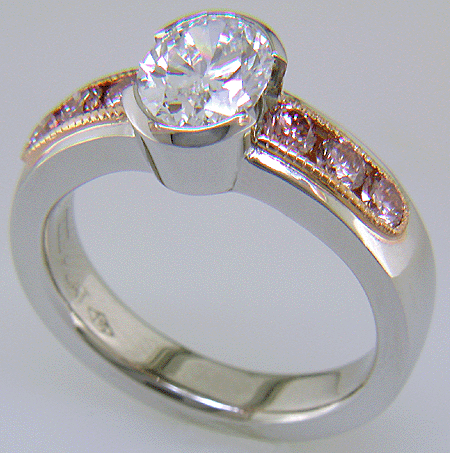 Oval Diamond set with 6 brilliant Pink Diamonds in a custom rose gold and platinum ring.
