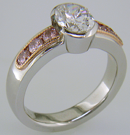 Oval Diamond set with 6 brilliant Pink Diamonds in a custom rose gold and platinum ring.
