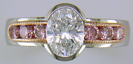 Oval Diamond set with 6 brilliant Pink Diamonds in a custom rose gold and platinum ring.