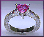 Hand engraved platinum ring with a trillium pink sapphire.