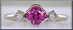 Pink Sapphire set with two Princess-cut diamonds in a platinum ring. (J8547)