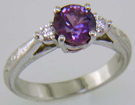 Purple Sapphire set with two round diamonds in a hand-engraved platinum ring. (J8525)