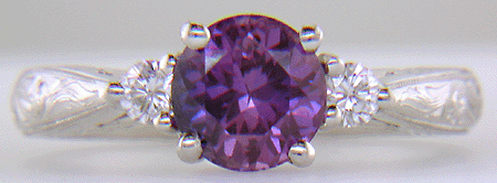 Purple Sapphire set with two round diamonds in a hand-engraved platinum ring. (J8525)