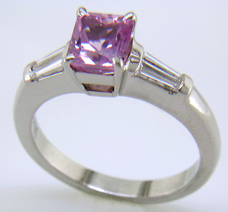 A radiant Pink Spinel set with tapered baguette diamonds in a custom platinum ring.