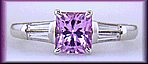 A radiant Pink Spinel set with tapered baguette diamonds in a custom platinum ring.