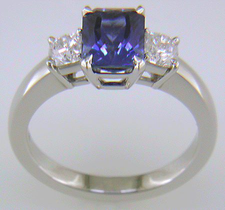 Side view of hand-crafted platinum ring with a sriking Radiant-cut Sapphire and two sparkling Flanders-cut diamonds.