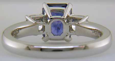 Inside view of hand-crafted platinum ring with a sriking Radiant-cut Sapphire and two sparkling Flanders-cut diamonds.