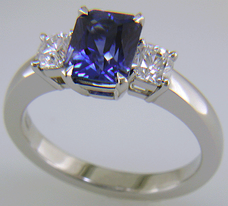 A hand-crafted platinum ring with a sriking Radiant-cut Sapphire and two sparkling Flanders-cut diamonds.