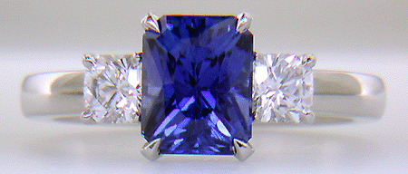 A hand-crafted platinum ring with a sriking Radiant-cut Sapphire and two sparkling Flanders-cut diamonds.