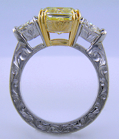 Side view of platinum anniversary ring with a fancy yellow diamond.
