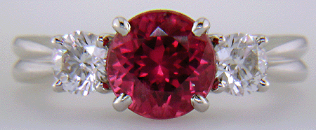 A Red spinel set with two ideal-cut diamonds in a beautiful platinum ring.