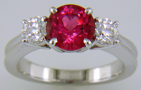 A Red spinel set with two ideal-cut diamonds in a beautiful platinum ring.