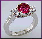 A Red spinel set with two ideal-cut diamonds in a beautiful platinum ring.