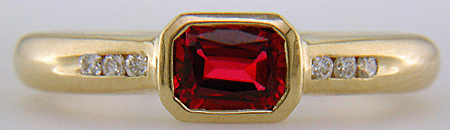 Emerald-cut Red Spinel set with round brilliant-cut diamonds in a hand-crafted ring. (J6776)