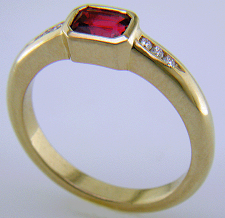 Emerald-cut Red Spinel set with round brilliant-cut diamonds in a hand-crafted ring. (J6776)