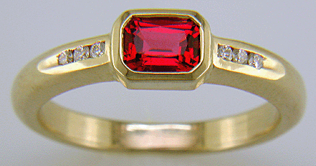 Emerald-cut Red Spinel set with round brilliant-cut diamonds in a hand-crafted ring. (J6776)