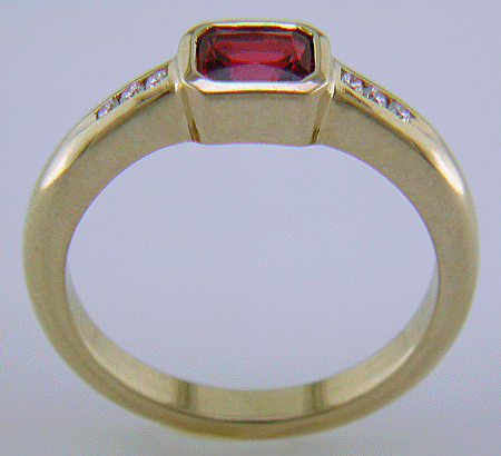 Emerald-cut Red Spinel set with round brilliant-cut diamonds in a hand-crafted ring. (J6776)