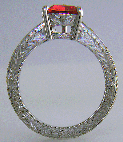 Side view of hand engraved platinum ring with a trillium red spinel.