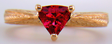 Hand engraved rose gold ring with a trillium red spinel.