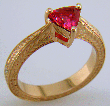 Hand engraved rose gold ring with a trillium red spinel.