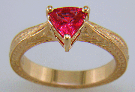 Hand engraved rose gold ring with a trillium red spinel.