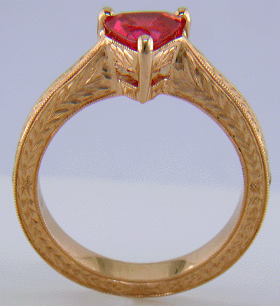 Side view of hand engraved rose gold ring with a trillium red spinel.