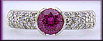 Pink sapphire and pave-set diamonds platinum ring.