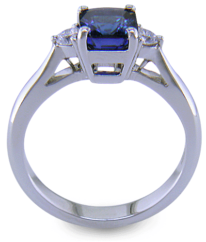 Side view of emerald-cut sapphire set with two round diamonds in a hand-crafted platinum ring. (J8540)