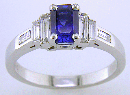 Emerald cut Sapphire and diamond platinum ring in an Art Deco style.