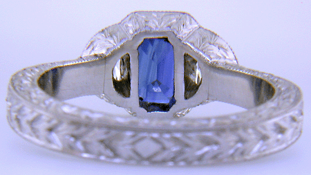 Inside view of emerald-cut saphire and half-moon diamond ring.