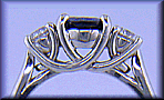 Platinum trellis ring set with an oval sapphire and two diamonds.