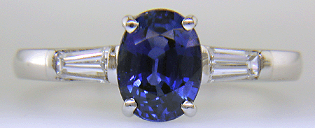 Oval Sapphire set with tapered baguette diamonds in a hand-crafted platinum ring.