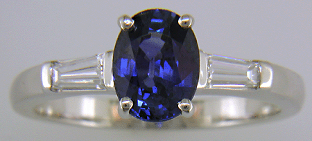 Oval Sapphire set with tapered baguette diamonds in a hand-crafted platinum ring.