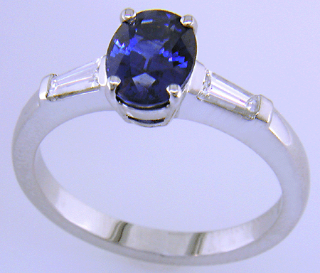 Oval Sapphire set with tapered baguette diamonds in a hand-crafted platinum ring.