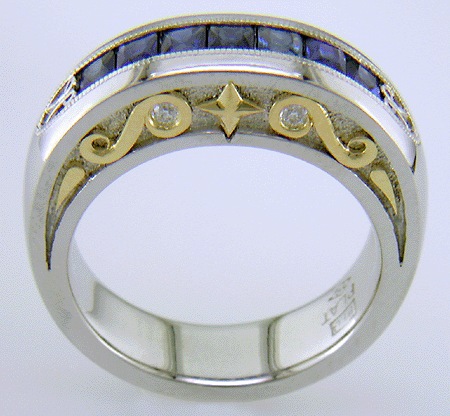 Seven Princess-cut Sapphires set in a platinum ring with diamonds and 18kt gold accents.