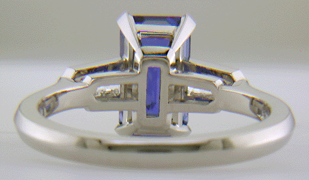 Inside view of hand-crafted platinum ring with a sriking emerald-cut Sapphire and sparkling bullet-shape diamonds.