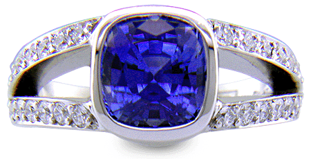 A cushion-cut sapphire set with diamonds in a custom platinum ring.
