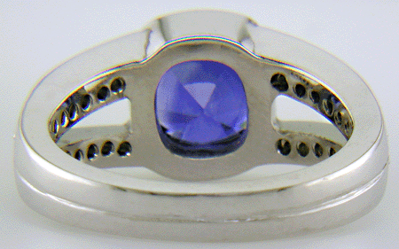 Inside view of a cushion-cut sapphire set with diamonds in a custom platinum ring.