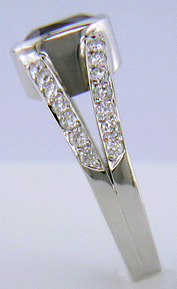 A cushion-cut sapphire set with diamonds in a custom platinum ring.