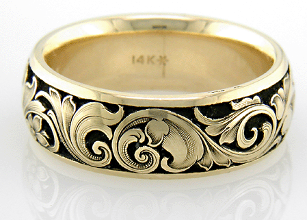 14kt godl band with floral relief engraving on a black background
