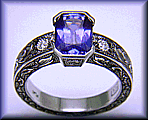 A striking engraved ring set with a beautiful violet blue sapphire.