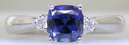 Square Cushion-cut Sapphire set with two round diamonds in a hand-crafted platinum ring. (J8599)