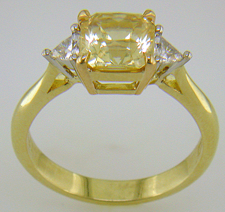 Side view of square-radiant-cut Yellow Sapphire set with two brilliant-cut diamonds in a hand-crafted 18kt gold and platinum ring. (J8711)
