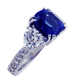 Engraved platinum ring with tanzanite and heart-shape diamonds.